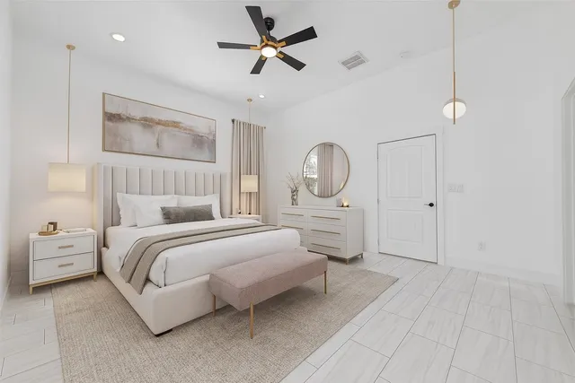 a bedroom with a bed couches chair and a large window