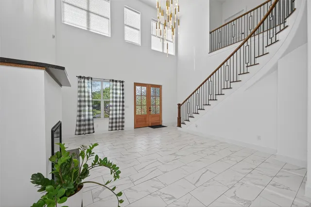 a living room with furniture a flat screen tv and a potted plant