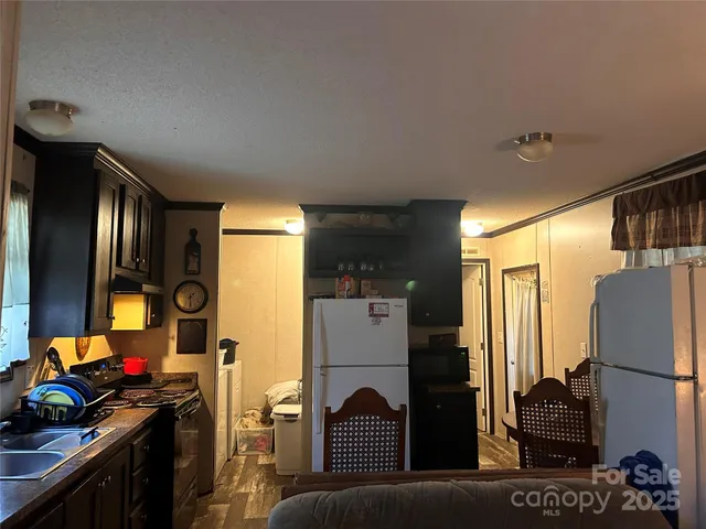 a kitchen with refrigerator a stove and a refrigerator