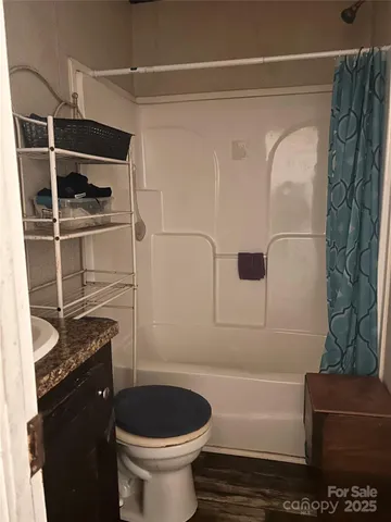 a bathroom with a toilet and a shower