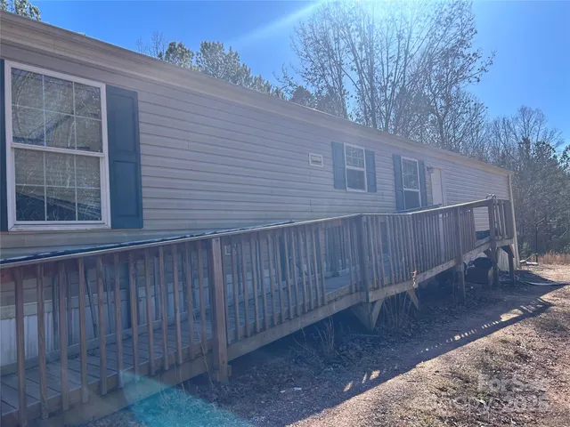 a view of a wooden house with a yard