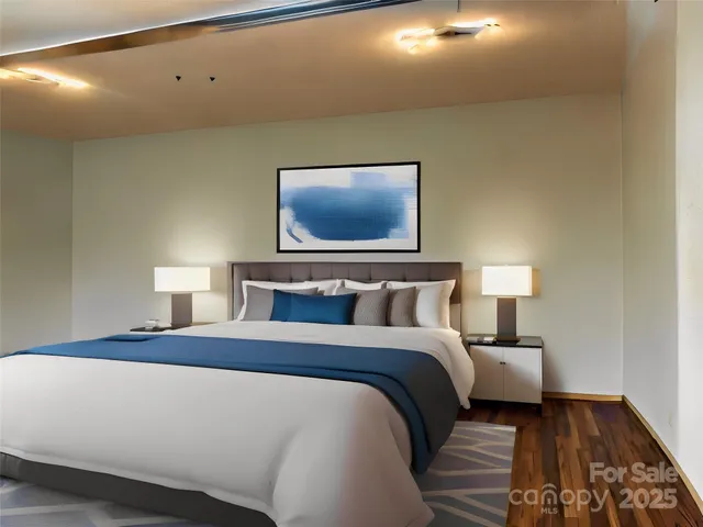 a bedroom with a bed and a lamp