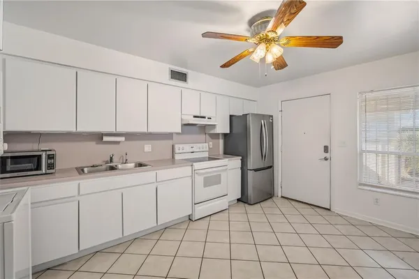 a kitchen with a sink cabinets and stainless steel appliances