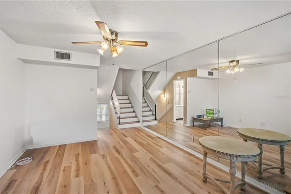 a room with lots of counter space and wooden floor