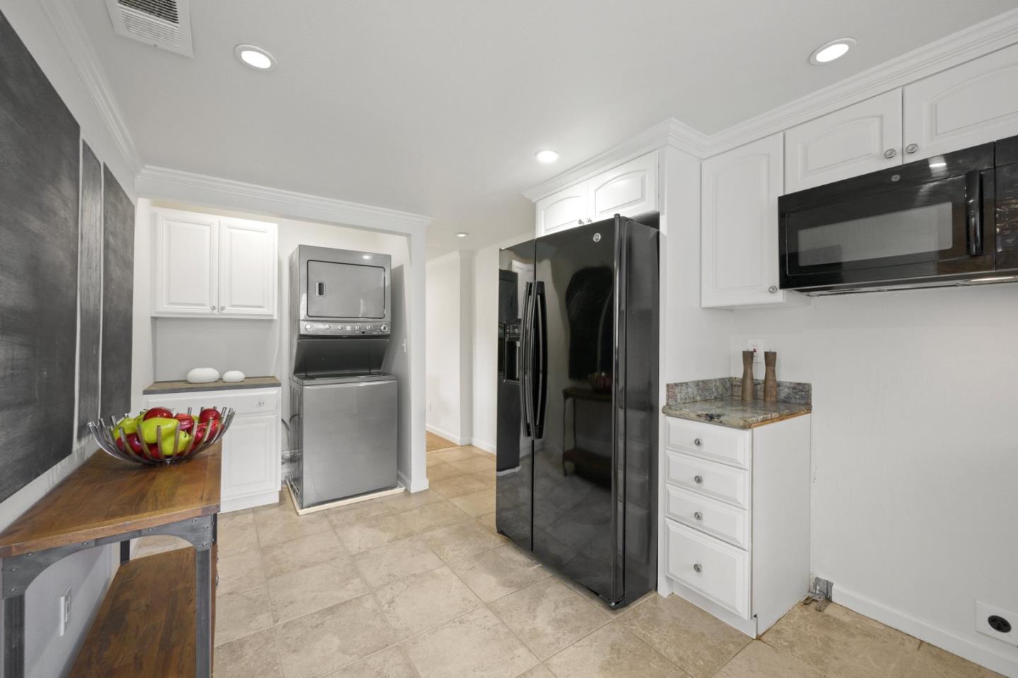 446 Hogarth Terrace Sunnyvale, CA 94087 - Photo 14 of 36 a kitchen with stainless steel appliances kitchen island granite countertop a refrigerator and a stove top oven