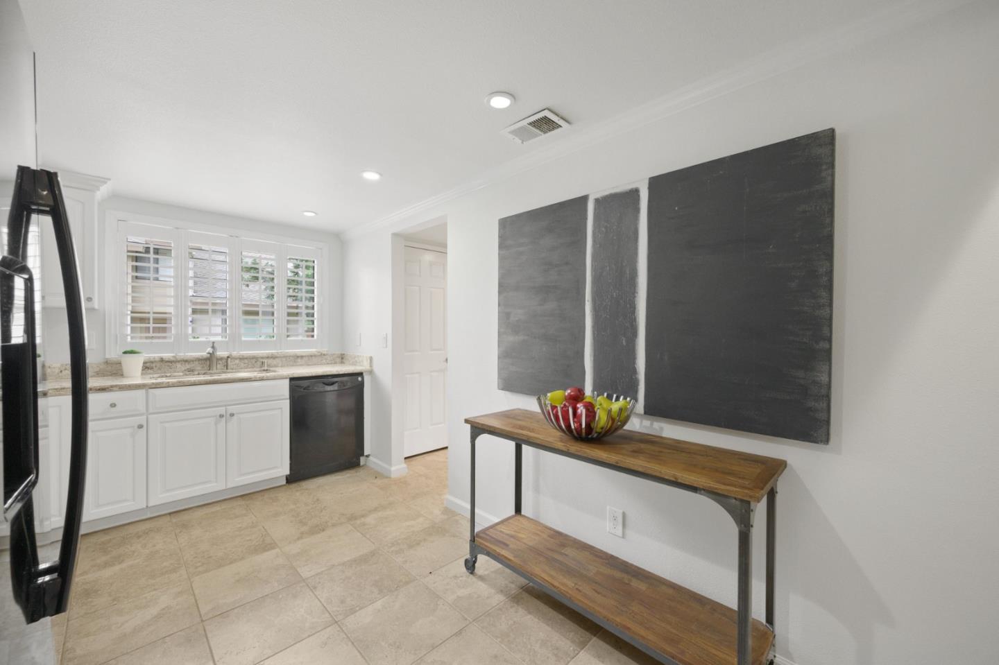 446 Hogarth Terrace Sunnyvale, CA 94087 - Photo 16 of 36 a room with stainless steel appliances kitchen island granite countertop a sink and a refrigerator