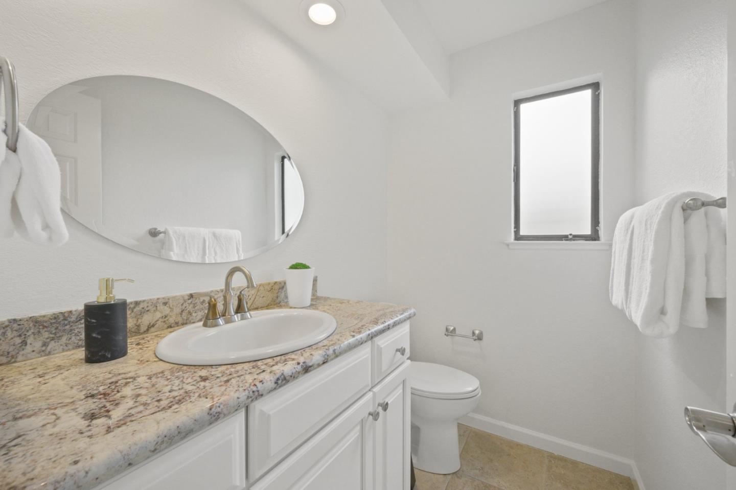 446 Hogarth Terrace Sunnyvale, CA 94087 - Photo 18 of 36 a bathroom with a granite countertop sink toilet and mirror