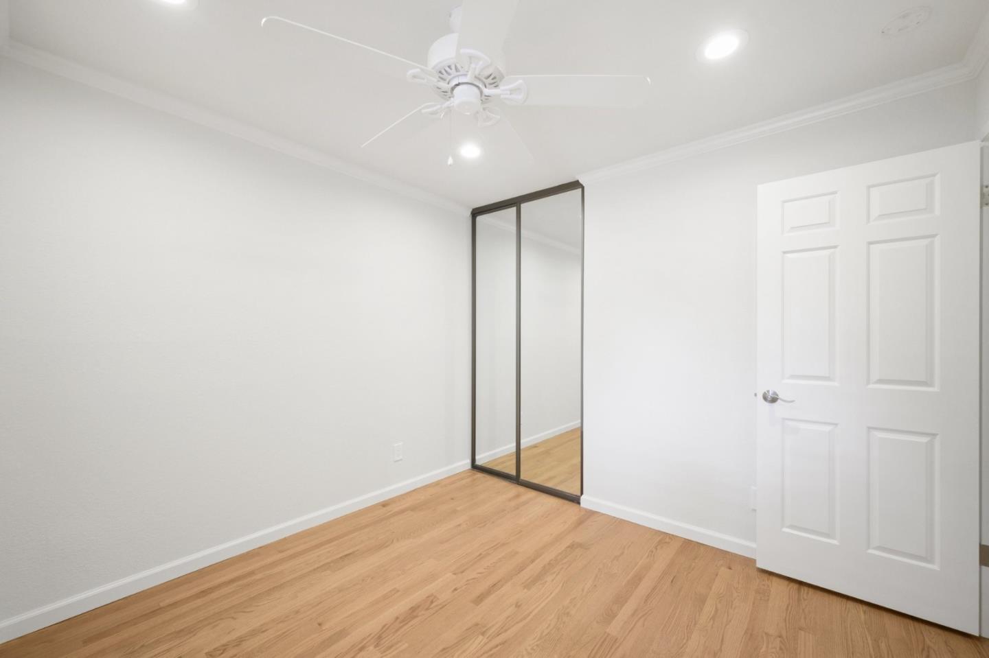 446 Hogarth Terrace Sunnyvale, CA 94087 - Photo 27 of 36 an empty room with wooden floor and fan