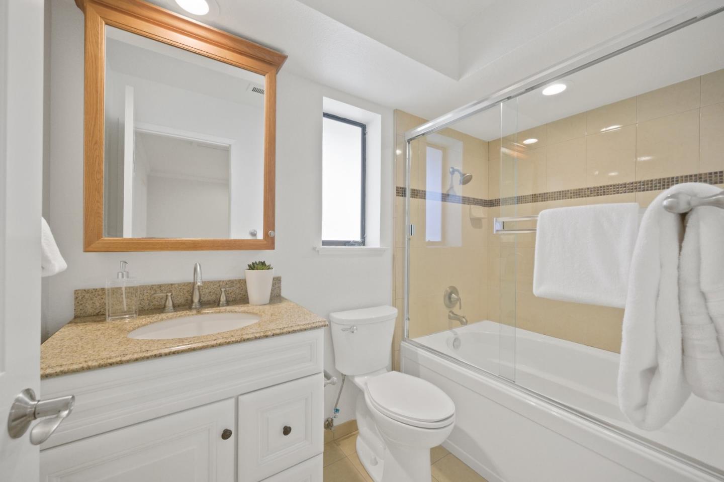 446 Hogarth Terrace Sunnyvale, CA 94087 - Photo 29 of 36 a bathroom with a granite countertop sink toilet and shower