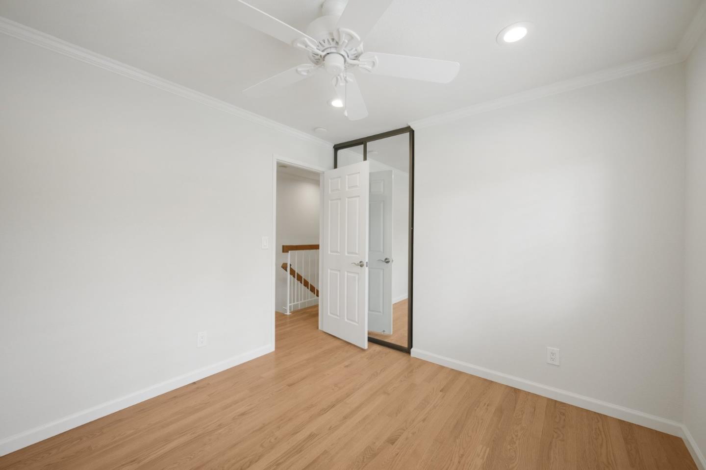 446 Hogarth Terrace Sunnyvale, CA 94087 - Photo 31 of 36 an empty room with wooden floor and ceiling fan