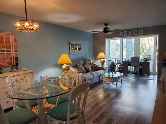 a living room with furniture dining table and a chandelier