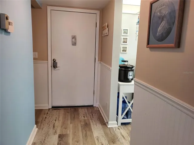 a view of hallway with wooden floor