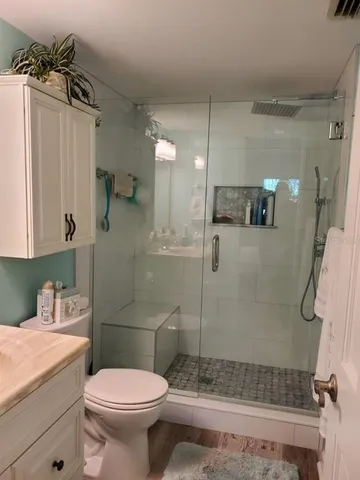 a bathroom with a sink toilet and shower