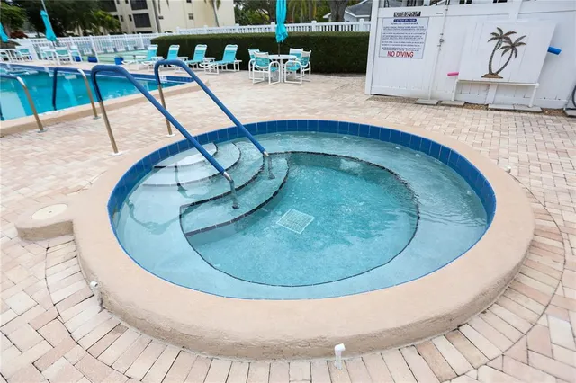 a view of swimming pool with a patio and a yard