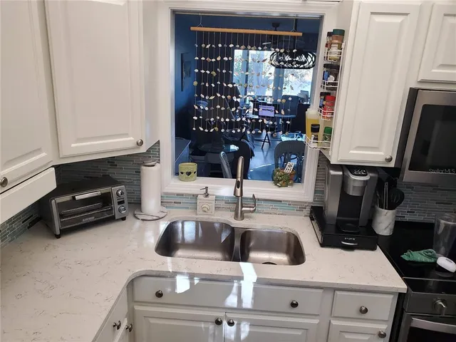a kitchen with a sink a stove and a refrigerator