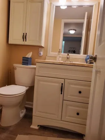 a bathroom with a toilet a sink and vanity