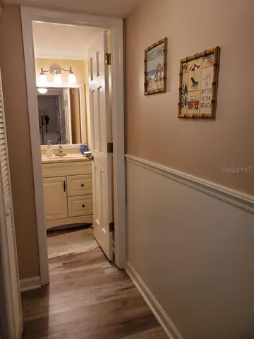a bathroom with a granite countertop sink mirror vanity and a shower