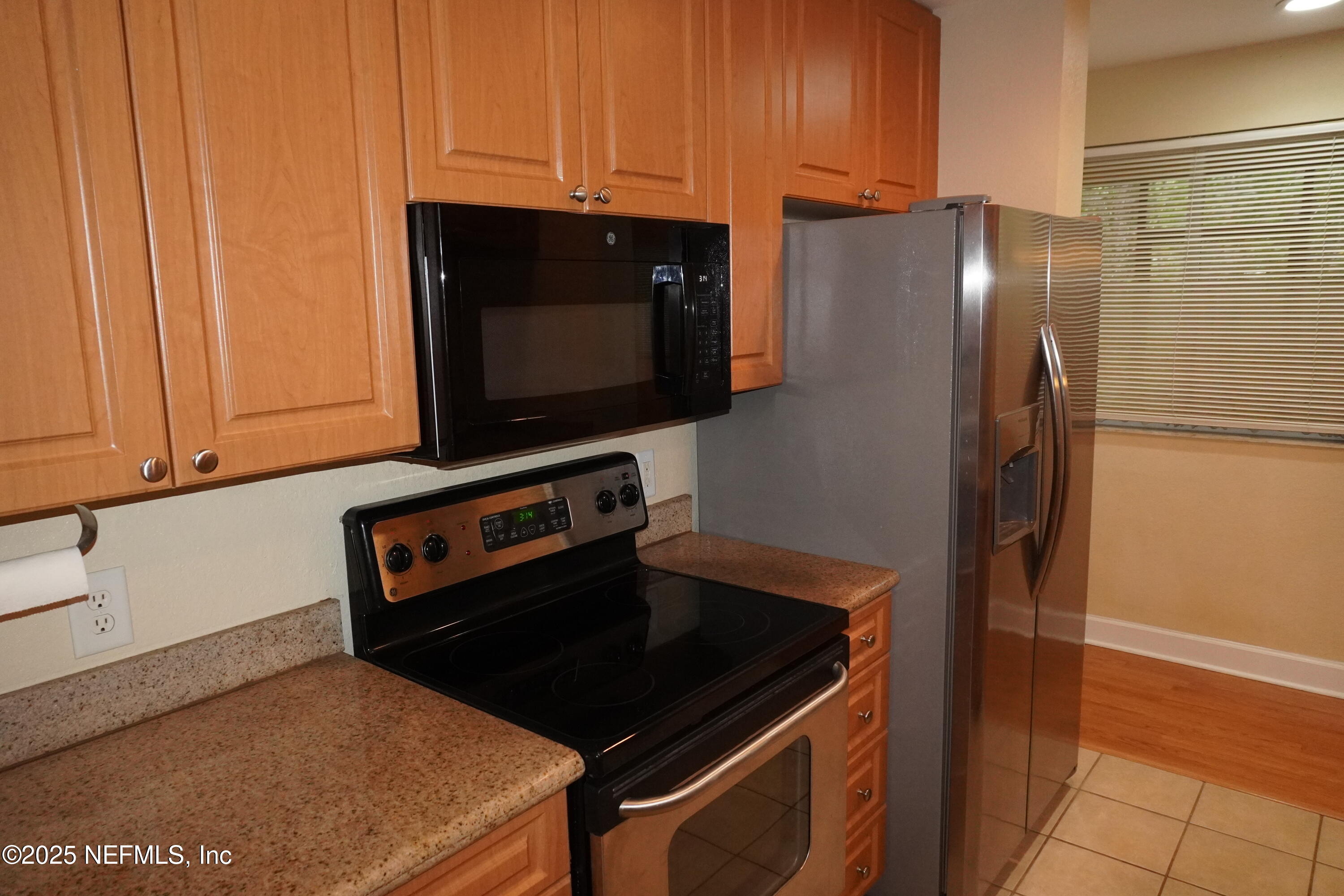 9745 Touchton Road, Unit 2201 Jacksonville, FL 32246 - Photo 12 of 32 a kitchen with stainless steel appliances a stove and a refrigerator