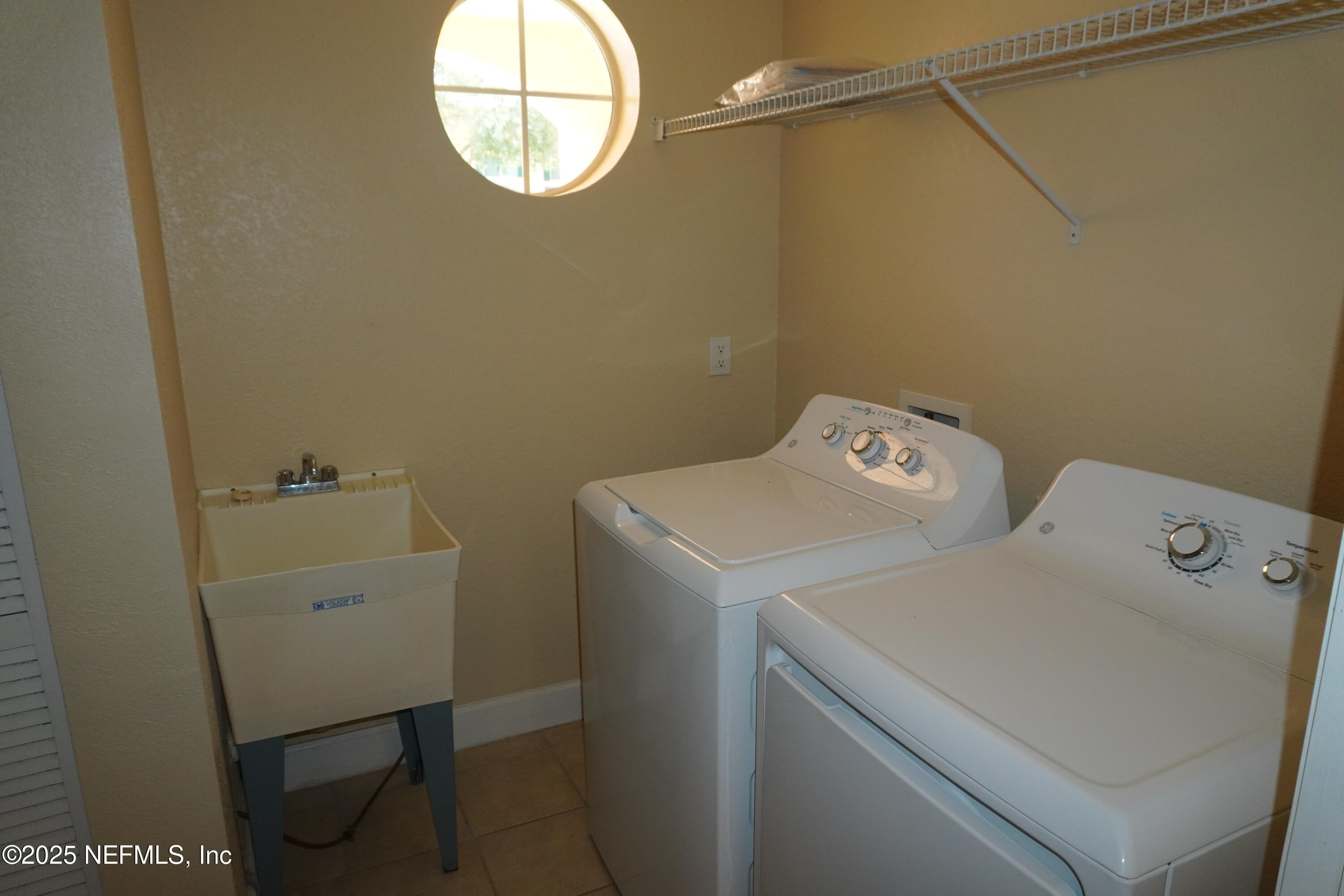 9745 Touchton Road, Unit 2201 Jacksonville, FL 32246 - Photo 14 of 32 a utility room with dryer and washer