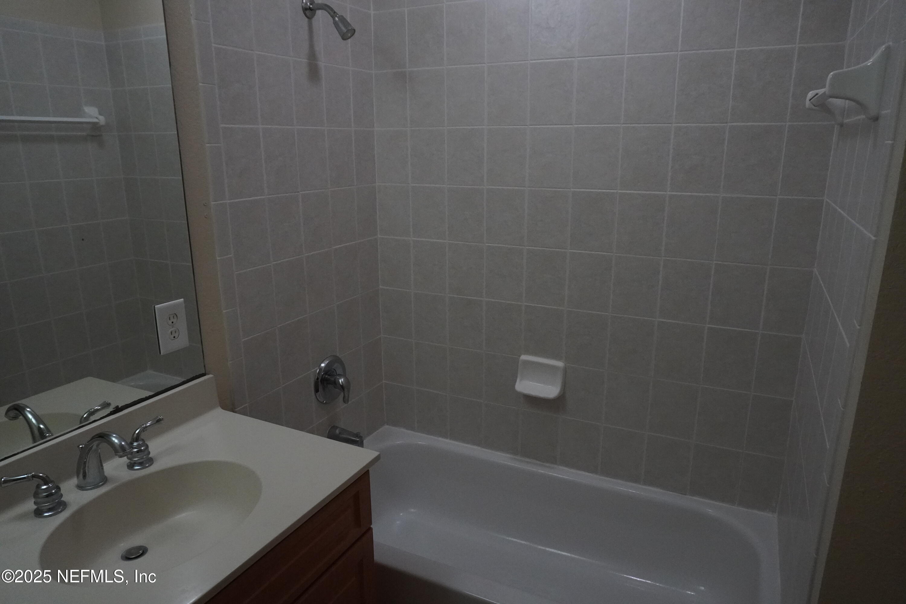 9745 Touchton Road, Unit 2201 Jacksonville, FL 32246 - Photo 19 of 32 a bathroom with a sink and shower