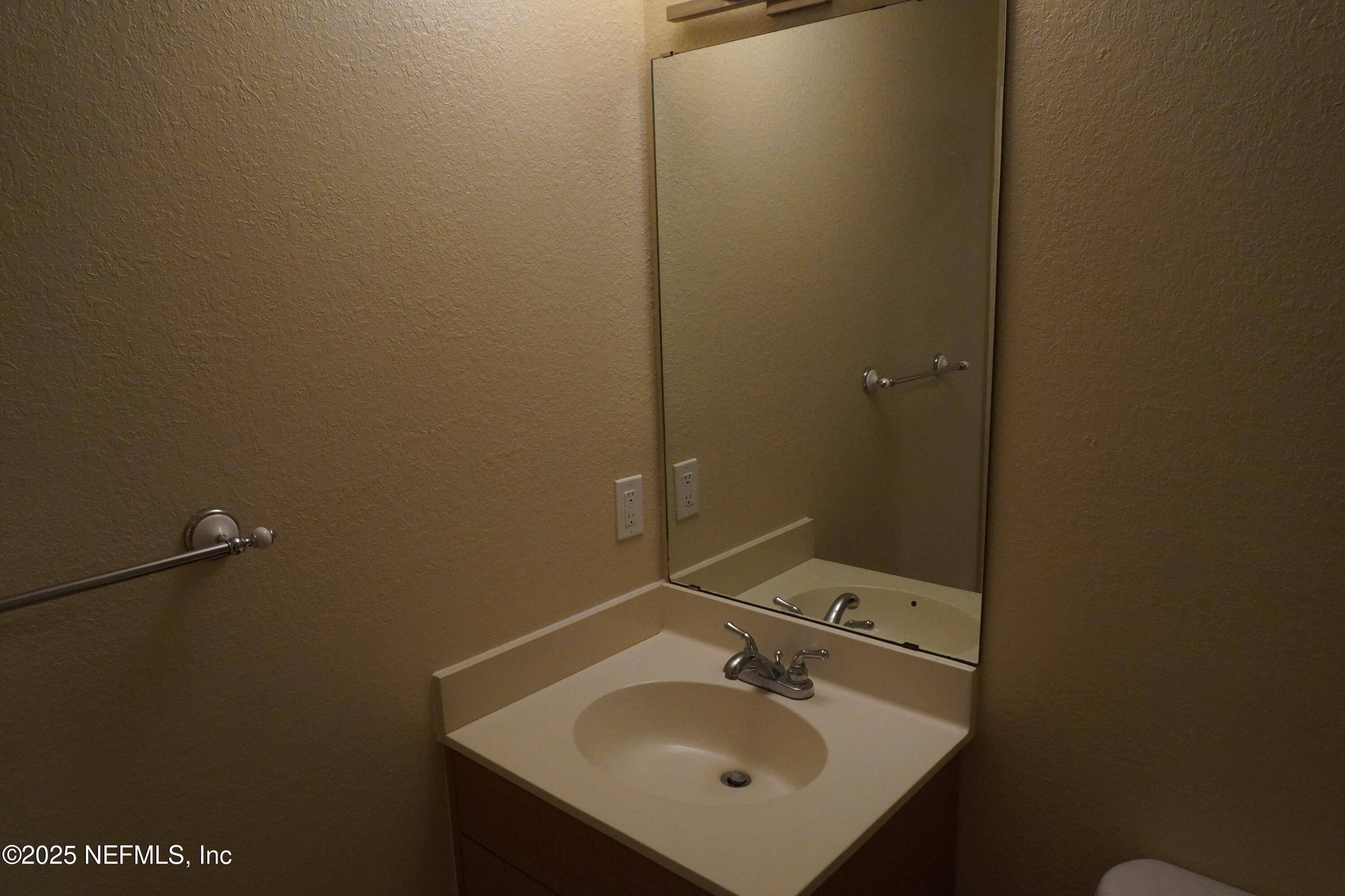 9745 Touchton Road, Unit 2201 Jacksonville, FL 32246 - Photo 23 of 32 a bathroom with a sink and mirror