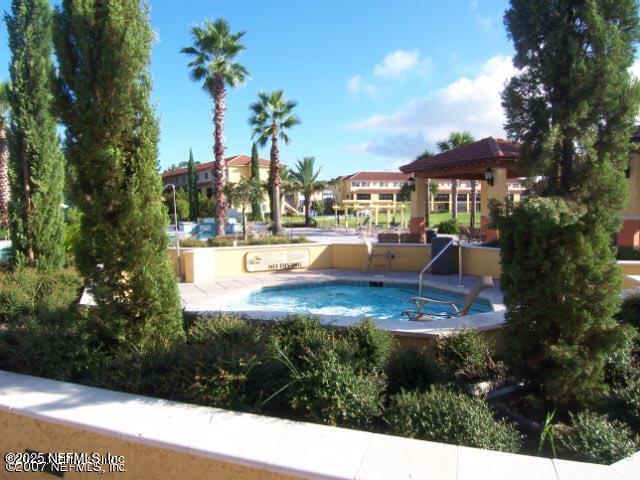 9745 Touchton Road, Unit 2201 Jacksonville, FL 32246 - Photo 29 of 32 a view of a swimming pool with a patio