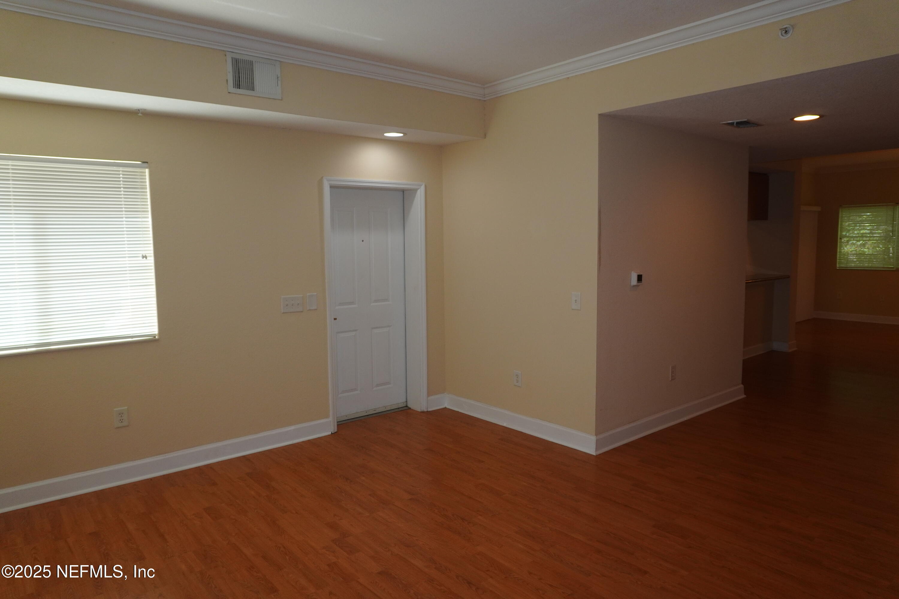 9745 Touchton Road, Unit 2201 Jacksonville, FL 32246 - Photo 4 of 32 an empty room with wooden floor and windows