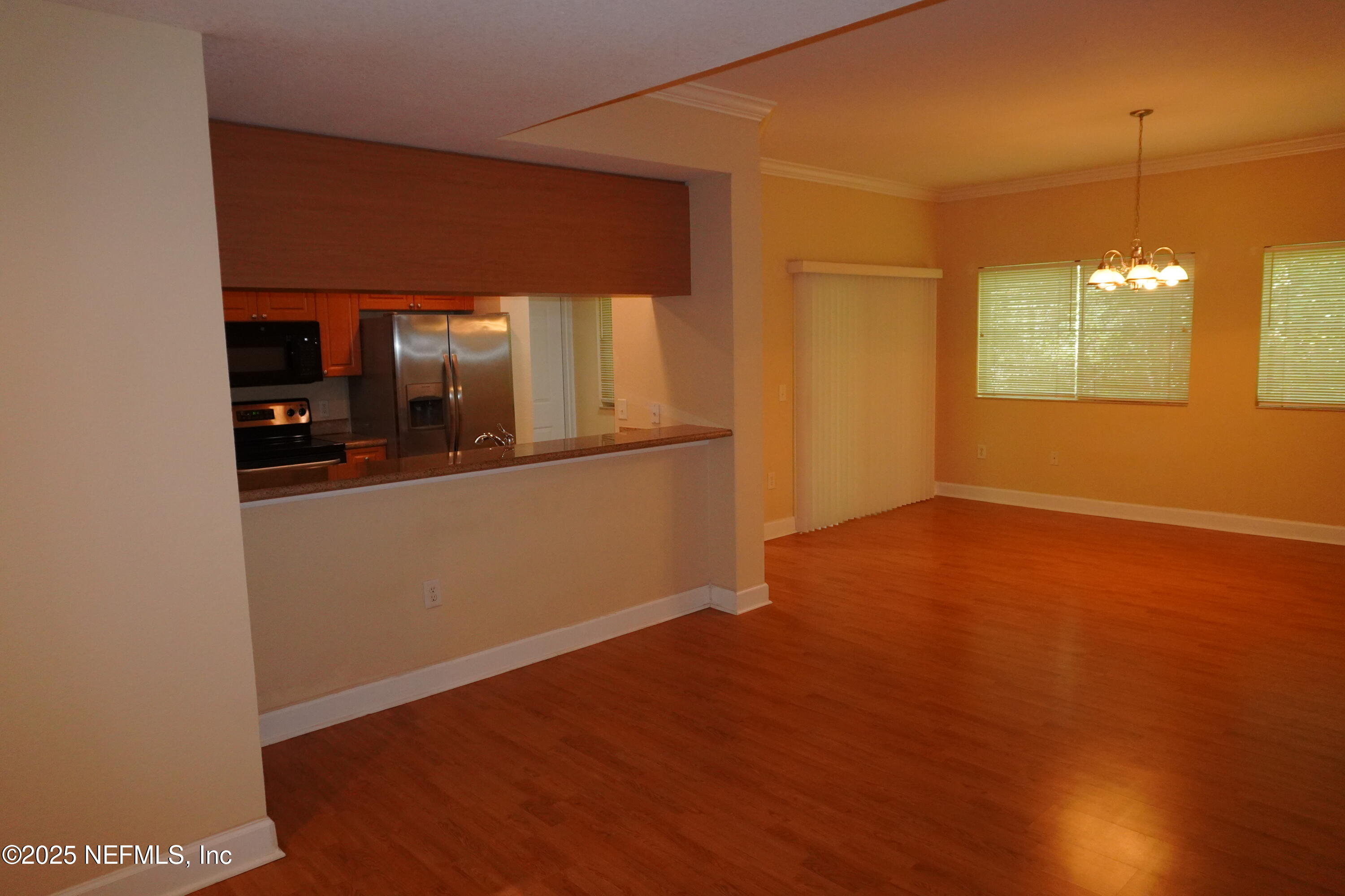 9745 Touchton Road, Unit 2201 Jacksonville, FL 32246 - Photo 6 of 32 a view of a room with wooden floor and staircase
