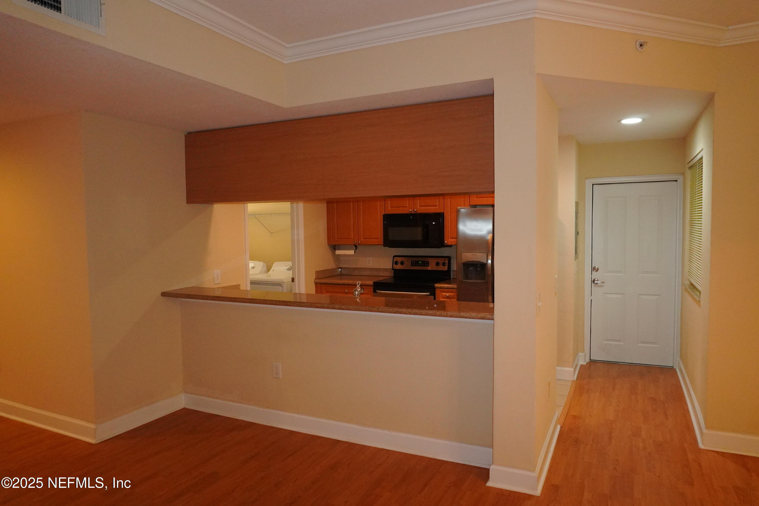 9745 Touchton Road, Unit 2201 Jacksonville, FL 32246 - Photo 9 of 32 a view of a kitchen from the hallway