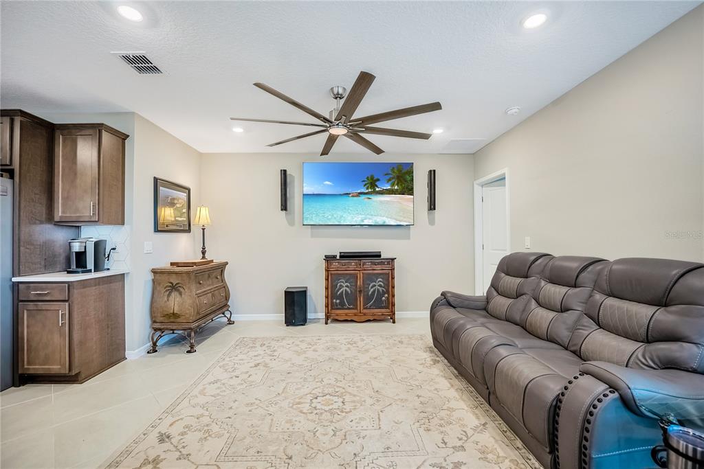 8344 Southwest 54th Loop Ocala, FL 34481 - Photo 9 of 36 a living room with furniture a fireplace and a flat screen tv