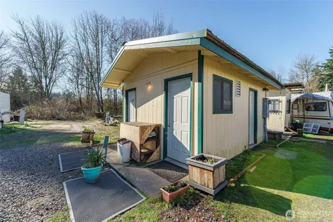 a front view of a house with garden and sitting area