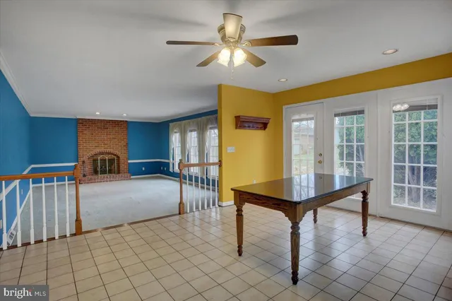 a living room with furniture fireplace and a large window