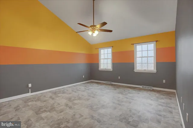 a view of a room with window and ceiling fan