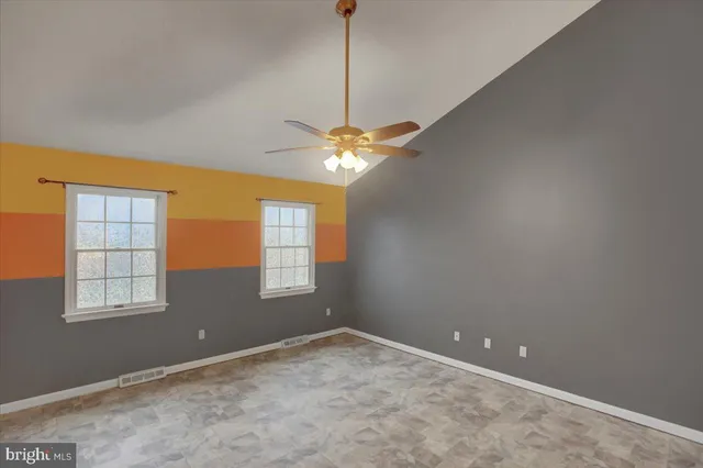 a bathroom with a toilet a double vanity sink a mirror and a shower