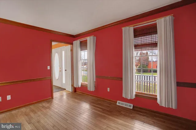 a room with walk in closet and wooden floor