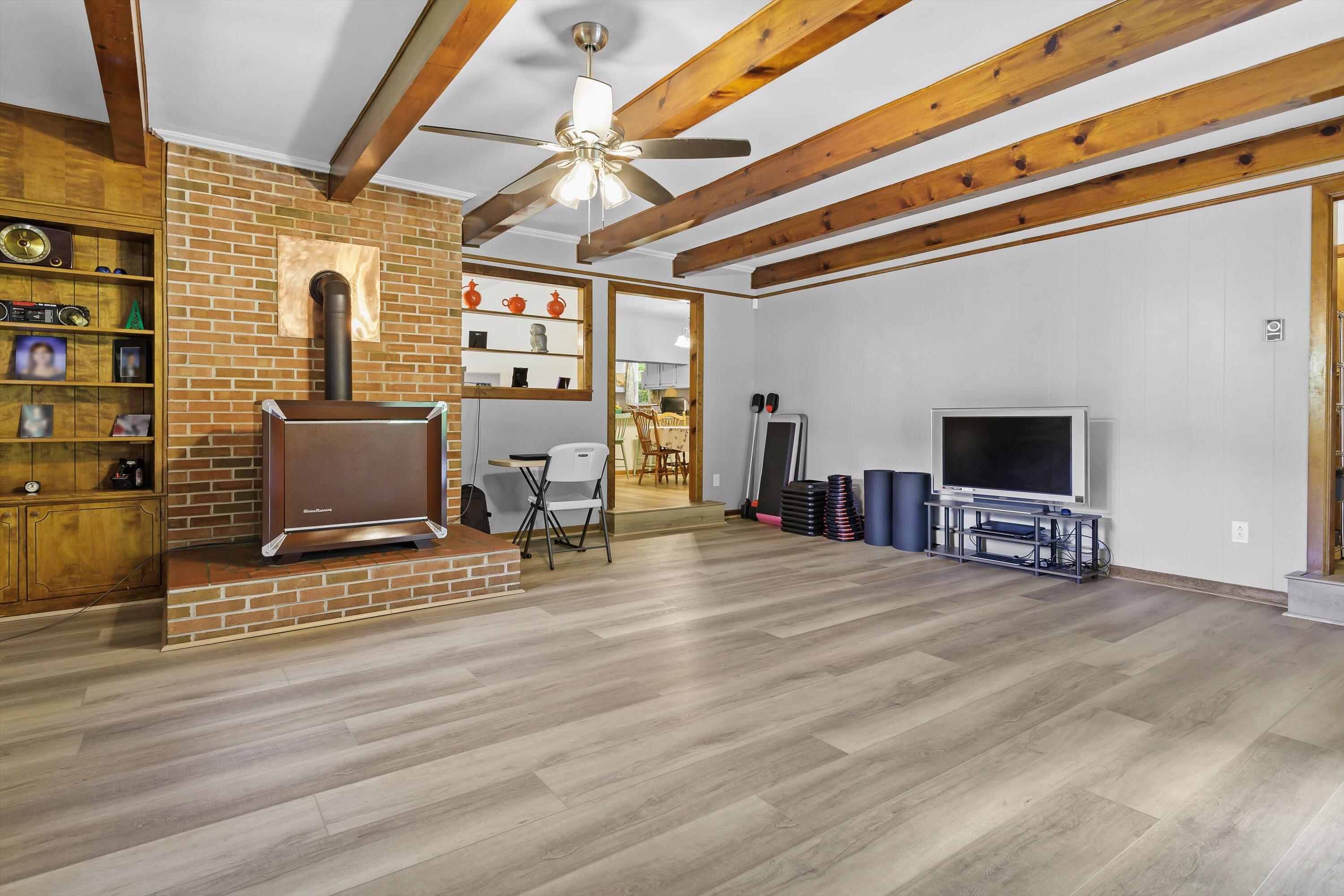2560 Fishers View Road Shawsville, VA 24162 - Photo 12 of 30 a view of an empty room with wooden floor and windows