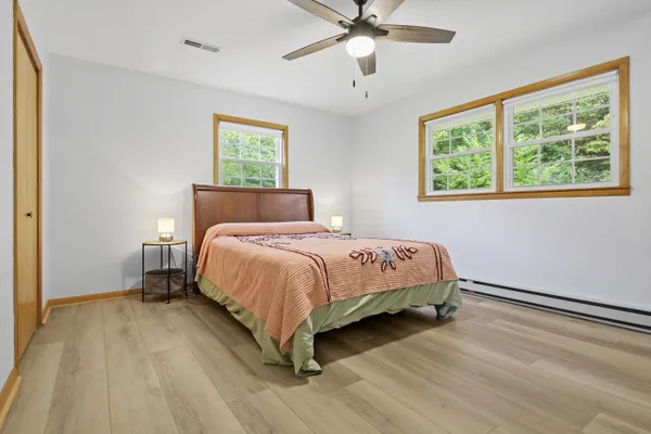 a bedroom with a bed and window