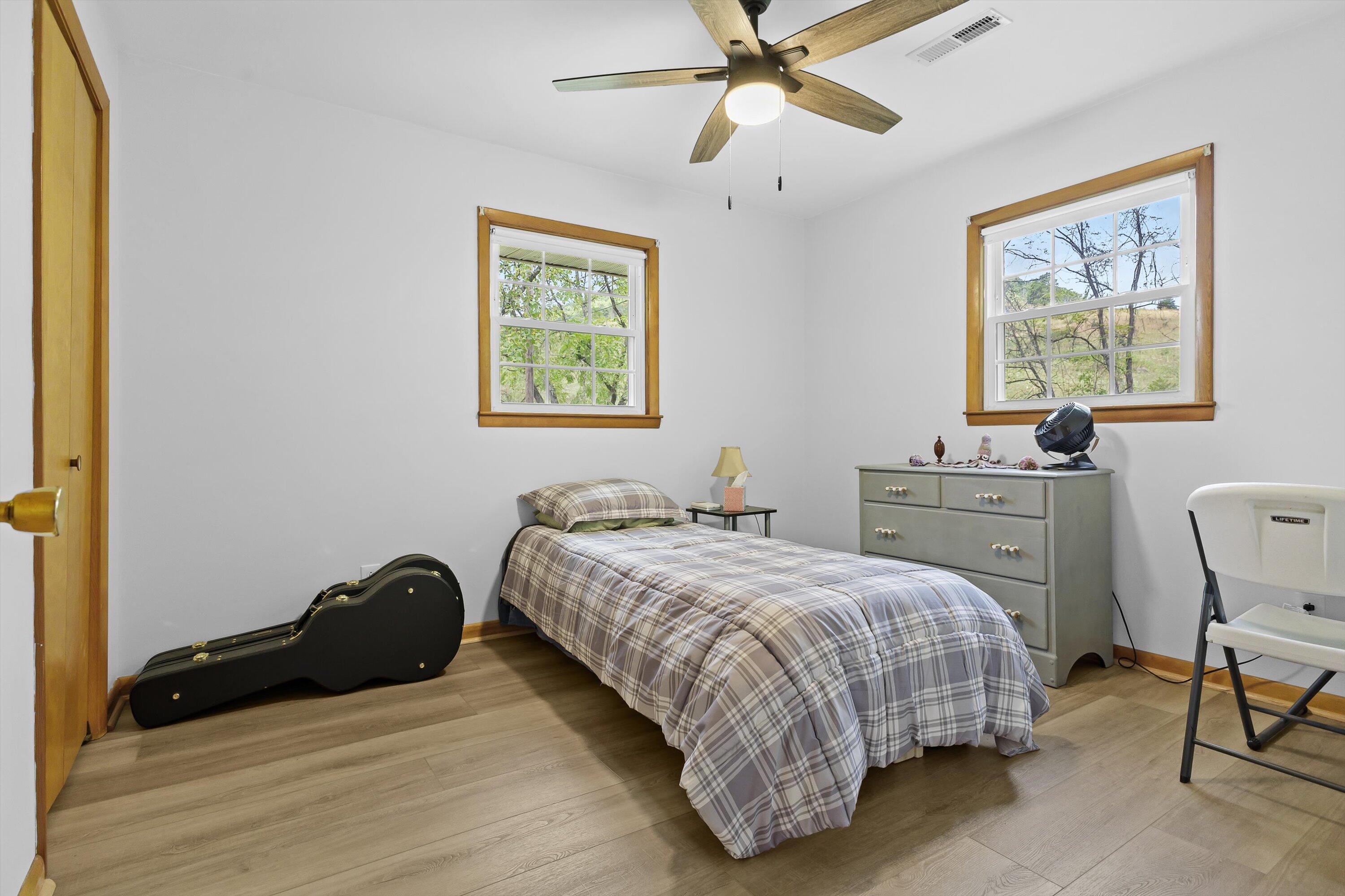 2560 Fishers View Road Shawsville, VA 24162 - Photo 19 of 30 a bedroom with a bed and a chandelier