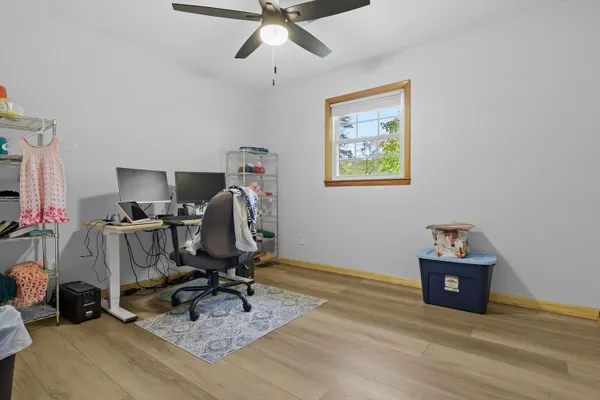 a view of workspace with furniture and wooden floor