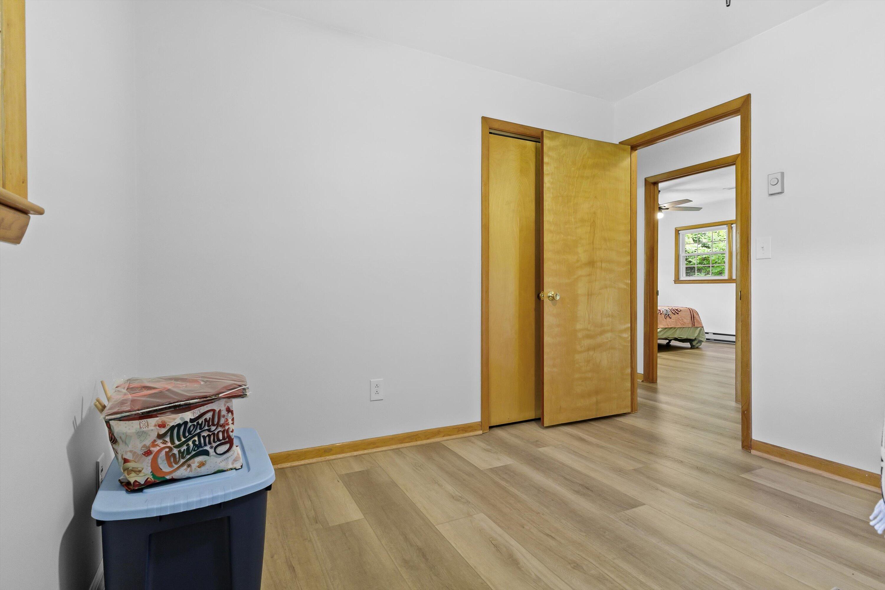 2560 Fishers View Road Shawsville, VA 24162 - Photo 22 of 30 a view of an empty room with wooden floor and a window