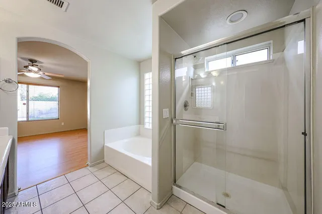a bathroom with a bathtub and a shower