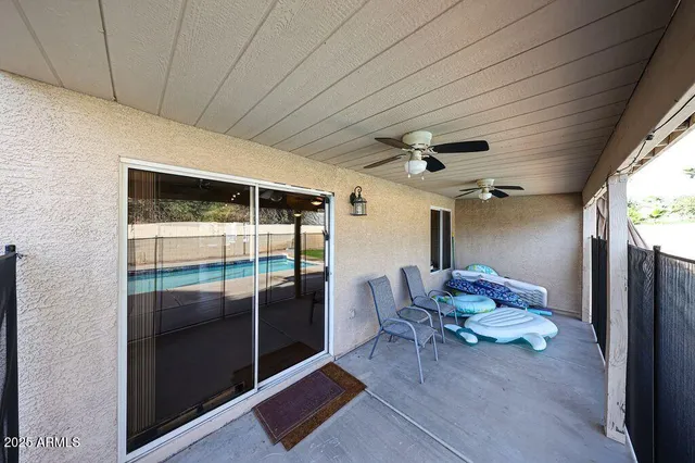 a view of a livingroom with furniture and a ceiling fan