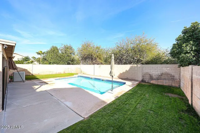 a view of a backyard with swimming pool