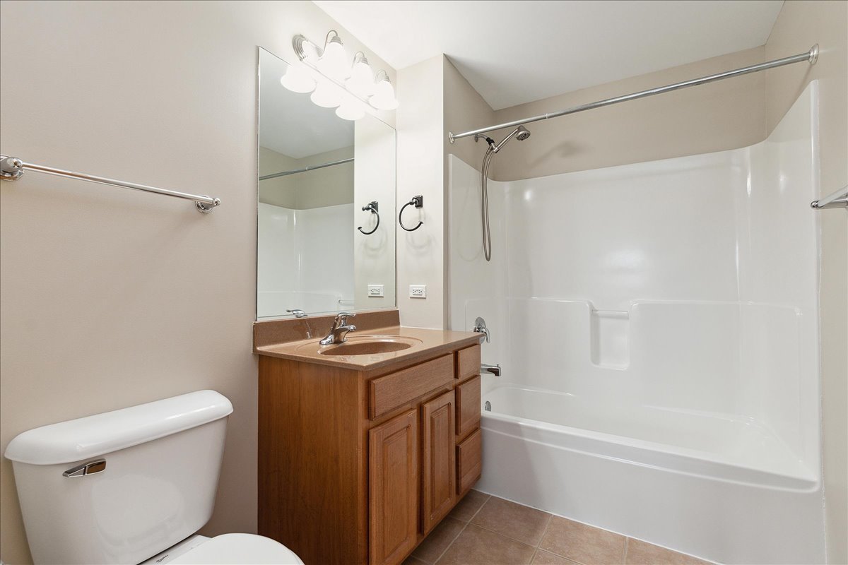 19806 Wolf Road, Unit 405 Mokena, IL 60448 - Photo 7 of 14 a bathroom with a granite countertop sink toilet and shower