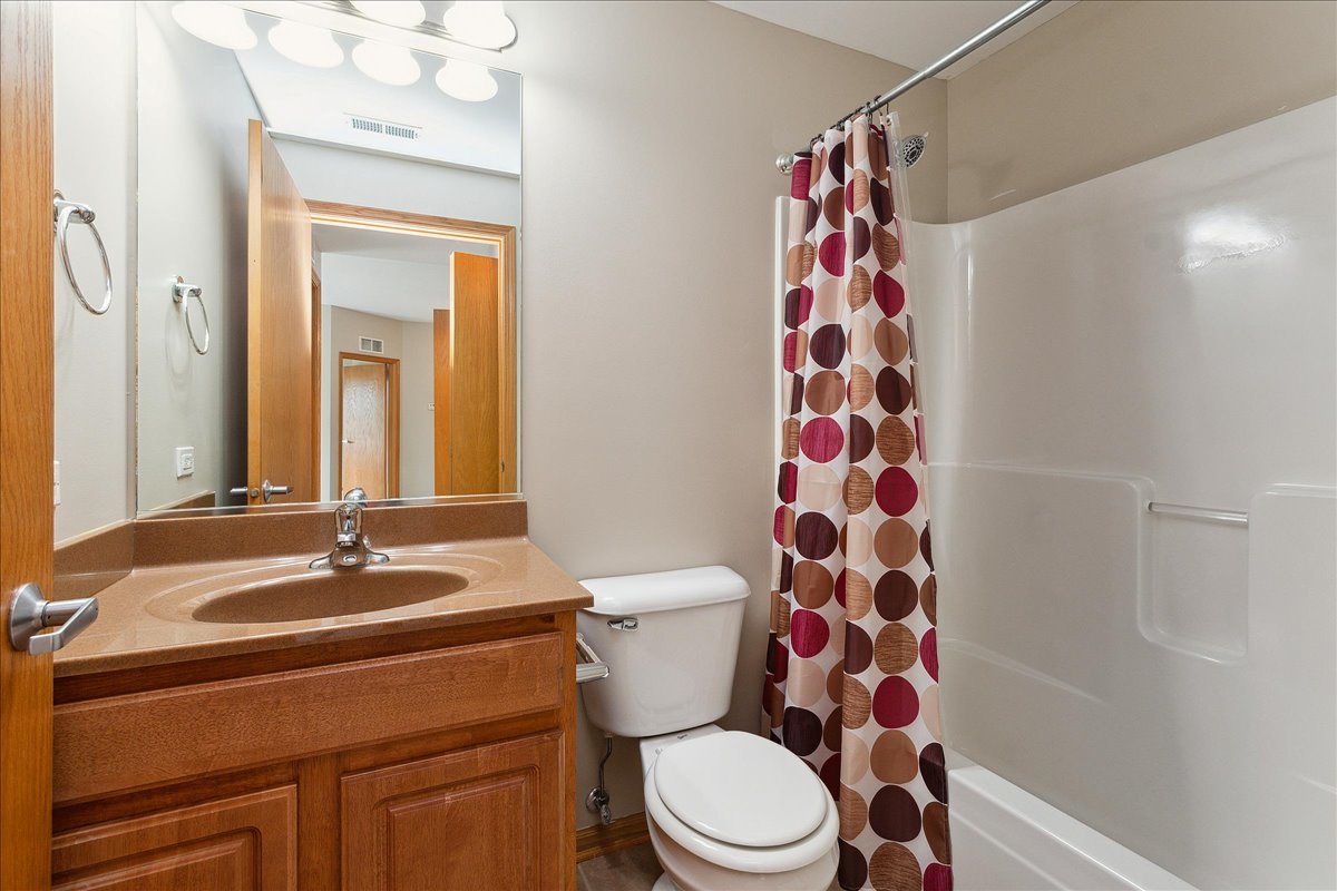 19806 Wolf Road, Unit 405 Mokena, IL 60448 - Photo 9 of 14 a bathroom with a sink a toilet and shower curtain