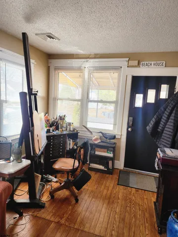 a workspace with furniture hardwood and a window