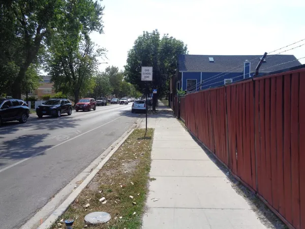 a view of street with parked cars