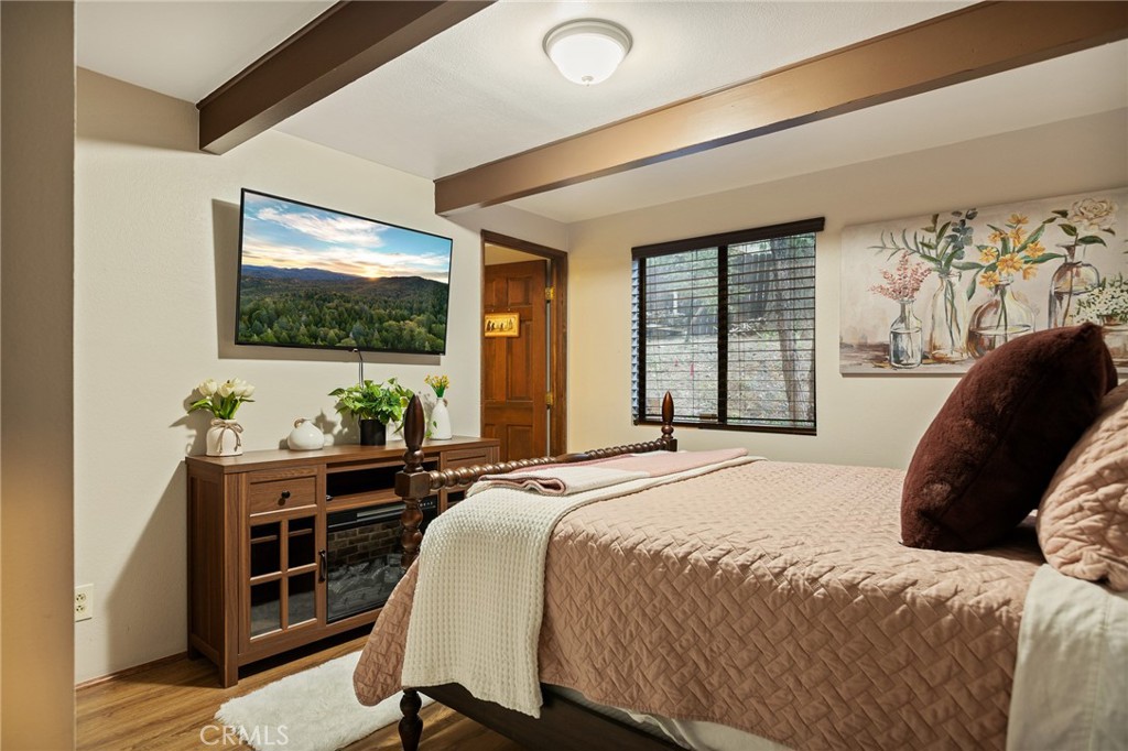 31353 Lightfoot Way Running Springs, CA 92382 - Photo 14 of 42 a bedroom with a bed and a flat screen tv