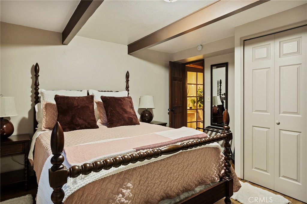 31353 Lightfoot Way Running Springs, CA 92382 - Photo 16 of 42 a bedroom with a bed and a window