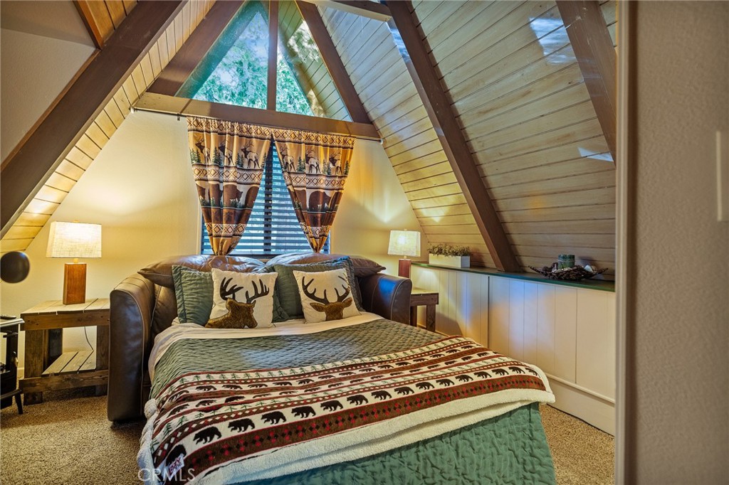 31353 Lightfoot Way Running Springs, CA 92382 - Photo 20 of 42 a bedroom with a bed and wooden floor